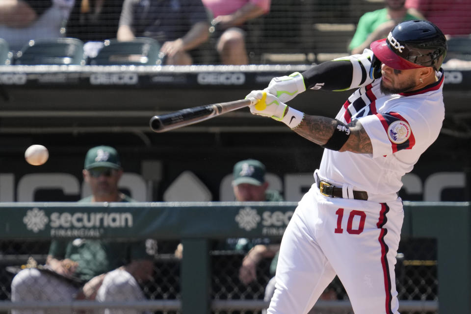 Chicago White Sox's Yoan Moncada hits a single during the first inning of a baseball game against the Oakland Athletics in Chicago, Sunday, Aug. 27, 2023. (AP Photo/Nam Y. Huh)