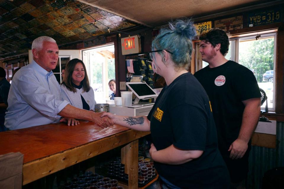 PHOTO: Republican presidential candidate former Vice President Mike Pence and his wife Karen Pence greet workers at Goody Coles BBQ Joint in Brentwood, New Hampshire, July 20, 2023. (Brian Snyder/Reuters)