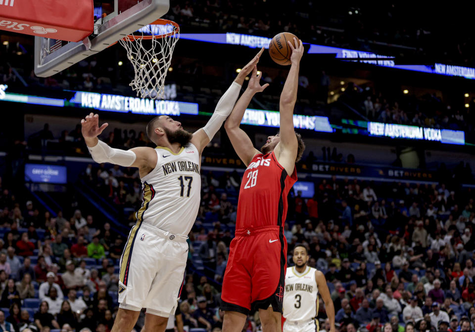 Houston Rockets center Alperen Sengun (28) shoots as New Orleans Pelicans center Jonas Valanciunas (17) defends during the first half of an NBA basketball game in New Orleans, Thursday, Feb. 22, 2024. (AP Photo/Derick Hingle)