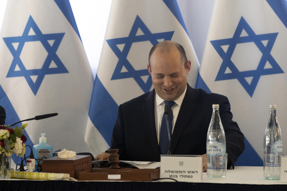 Israeli Prime Minister Naftali Bennett, center, chairs the weekly cabinet meeting in Kibbutz Mevo Hama, in the Israeli-occupied Golan Heights, Sunday, Dec. 26, 2021. Bennett said Sunday the country intends to double the amount of settlers living in the Israeli-controlled Golan Heights with a multimillion-dollar plan meant to further consolidate Israel’s hold on the territory it captured from Syria more than five decades ago. (Nir Elias/Pool via AP)