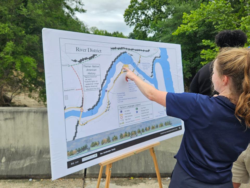 Hattiesburg Parks and Recreation Director Betsy Mercier looks at a map of the new trails that will be added along Gordon's Creek, during a news conference Monday.