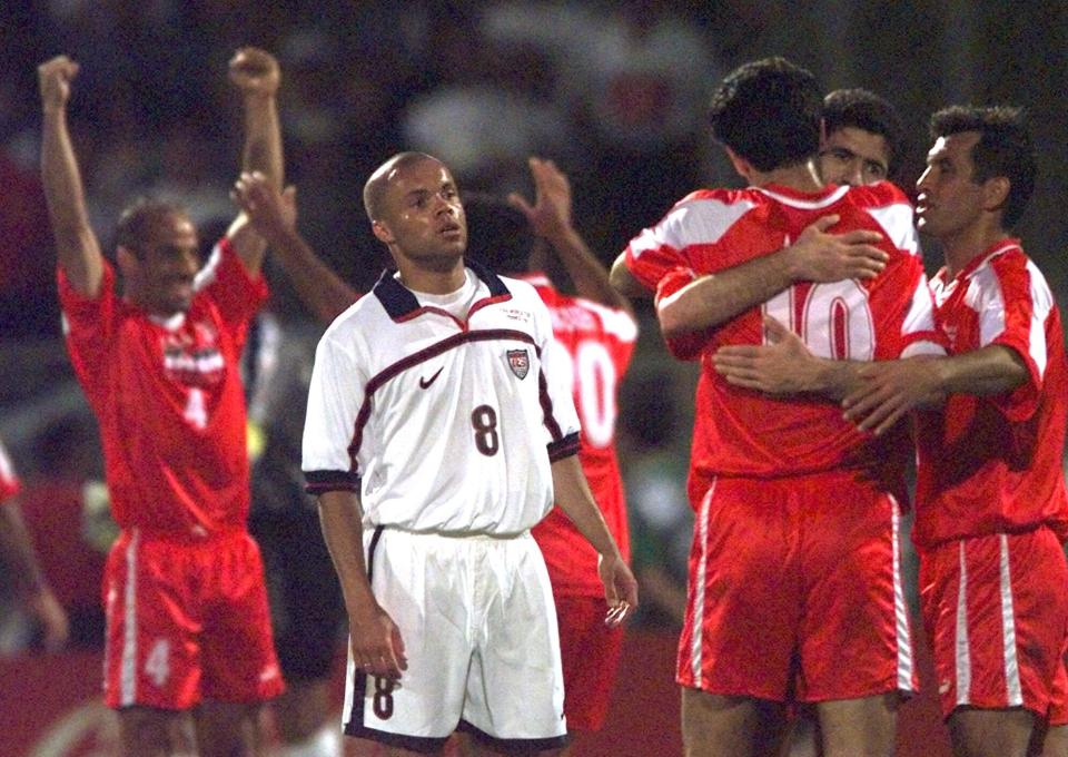 FILE - American Ernie Stewart stands dejected amid jubilant Iranian players Sunday, June 21, 1998, after their Group F World Cup soccer match at Gerland Stadium. Other teams in Group F are Germany and Yugoslavia. Iran defeated the USA 2-1. (AP Photo/Denis Doyle, File)