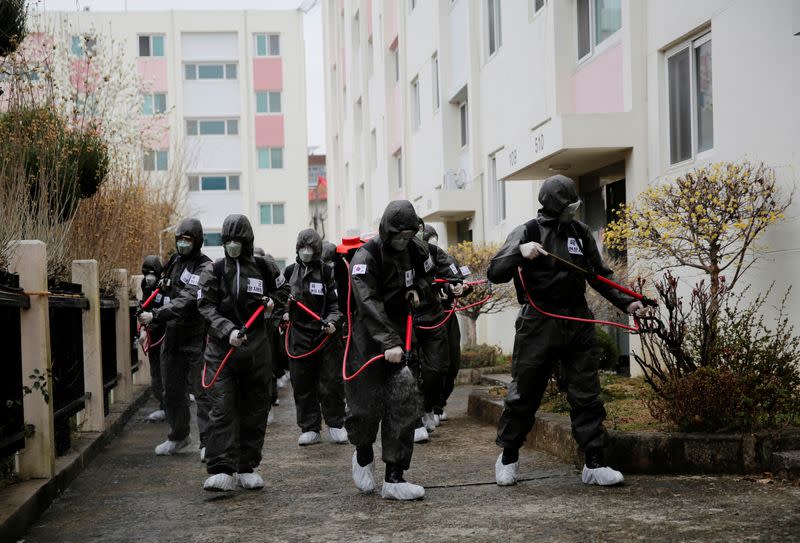 South Korean soldiers spray disinfectants at an apartment complex which is under cohort isolation after mass infection of coronavirus disease (COVID-19) in Daegu