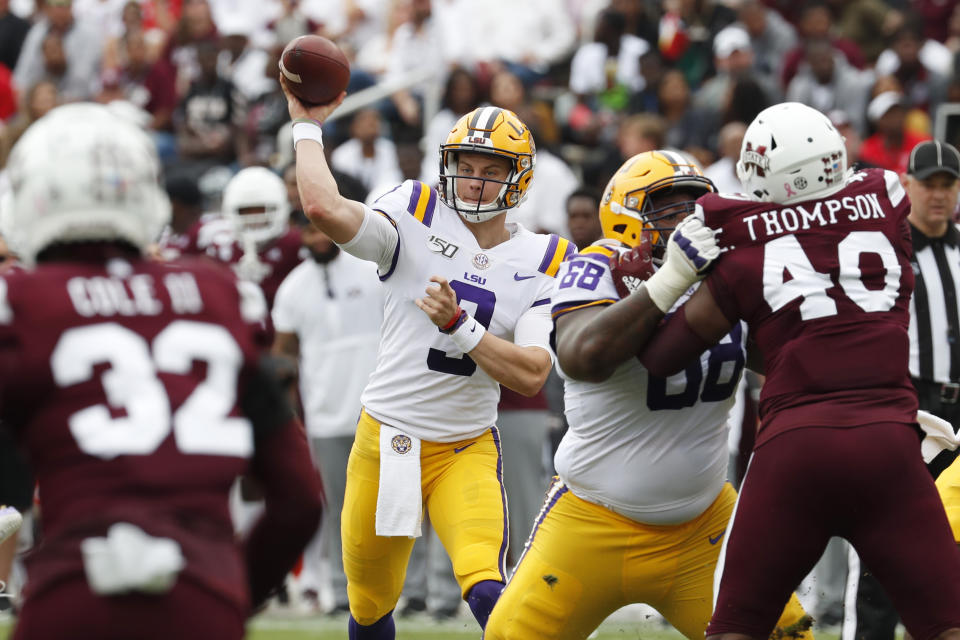 LSU quarterback Joe Burrow (9) passes for a first down against Mississippi State during the first half of their NCAA college football game in Starkville, Miss., Saturday, Oct. 19, 2019. In addition to LSU winning 36-13, Burrow threw four touchdowns to break the LSU season record with 29. (AP Photo/Rogelio V. Solis)