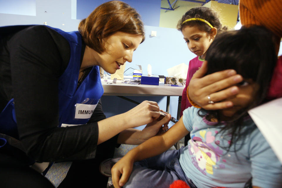 A child in Ontario receives a vaccination for the H1N1 virus in 2009. Only three provinces in Canada have legislation governing the vaccination of schoolchildren. Photo from Getty Images.