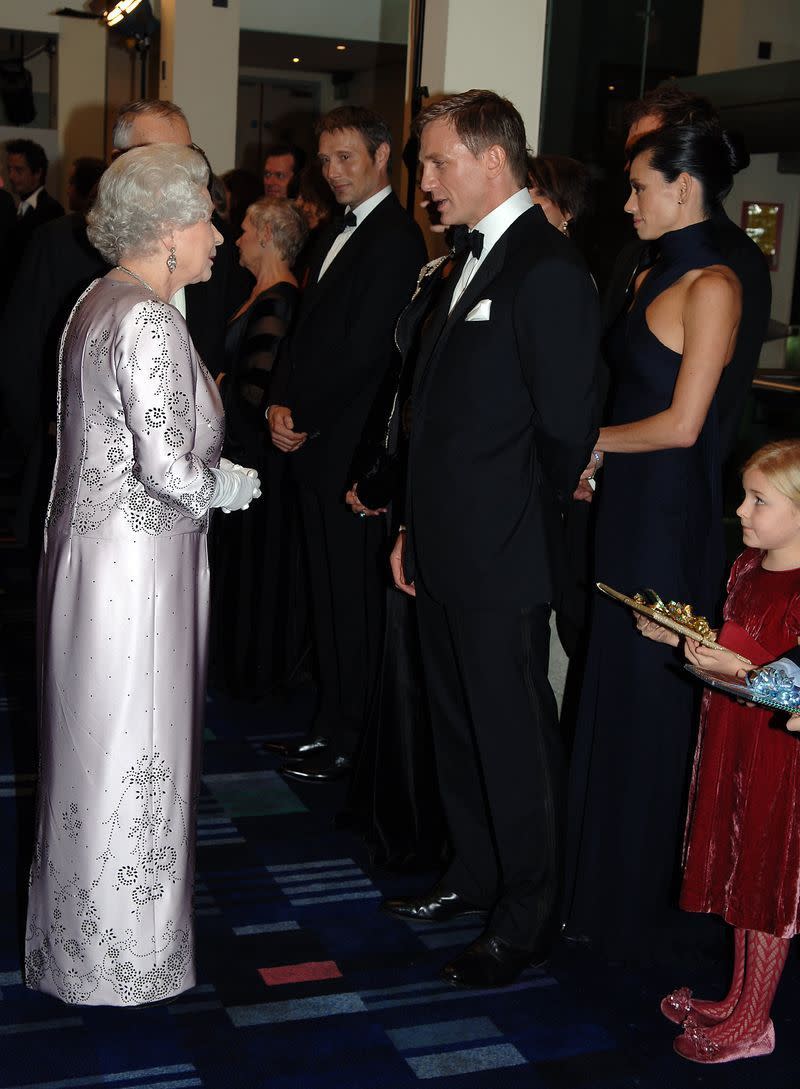 <p>We wonder if Queen Elizabeth is as charmed by Daniel Craig in a sharp tuxedo as we are. Judging by the look of their interaction here, we'd say yes. </p>