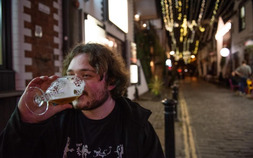Ashton Lane in the West End of Glasgow would normally be packed with students as it is close to The University of Glasgow but last nights as pubs closed early very few people were seen around. September 25, 2020. Pic: Cameron Paterson, 20, fourth year student, enjoys a pint on a quiet Ashton Lane. - James Chapelard 