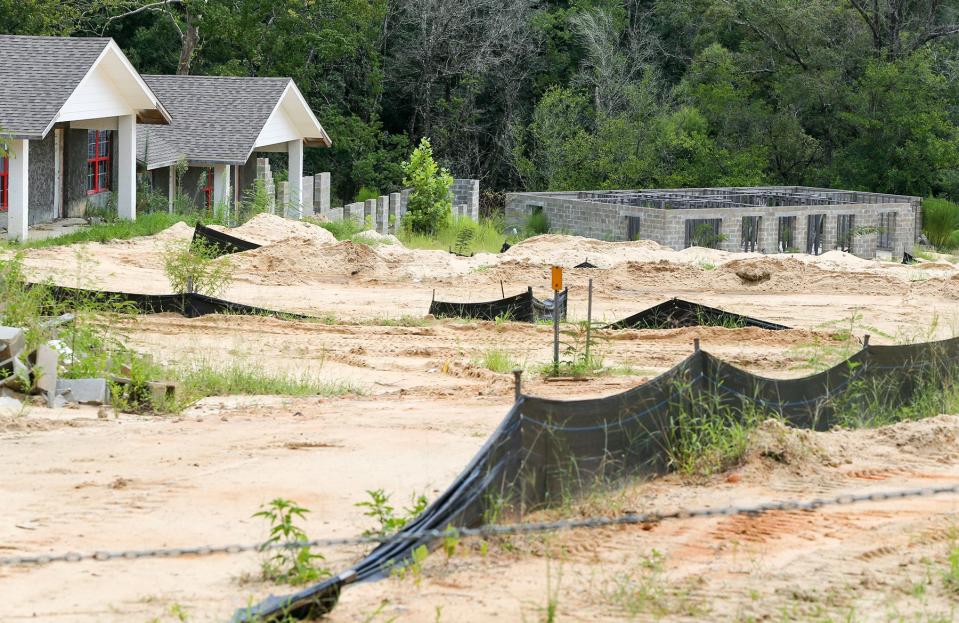 Homes are empty and some are unfinished in the Village Springs housing development in DeFuniak Springs. A city stop work order was posted in 2021.