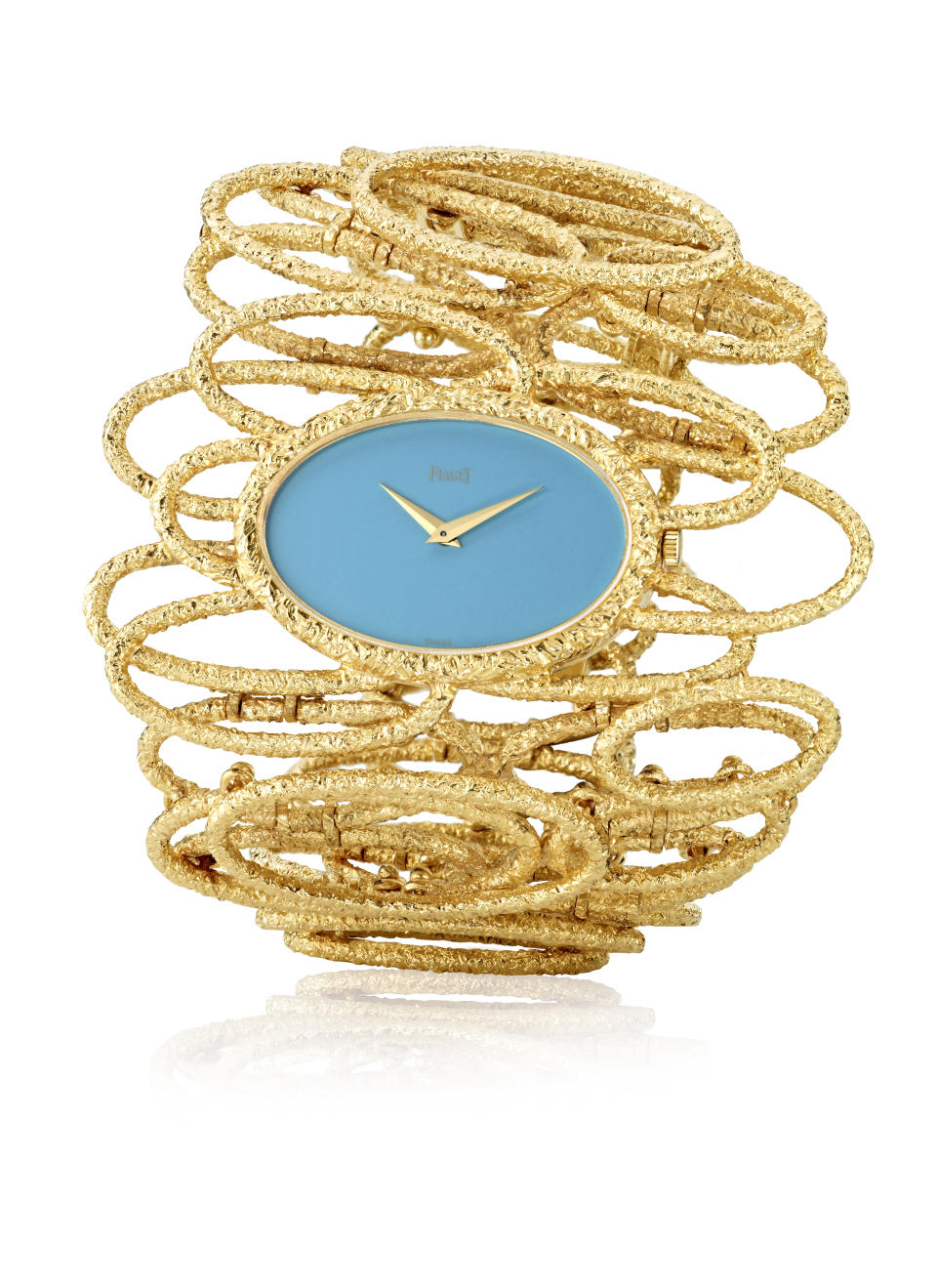 Piaget’s 1971 Private Collection cuff watch in yellow gold and turquoise dial.