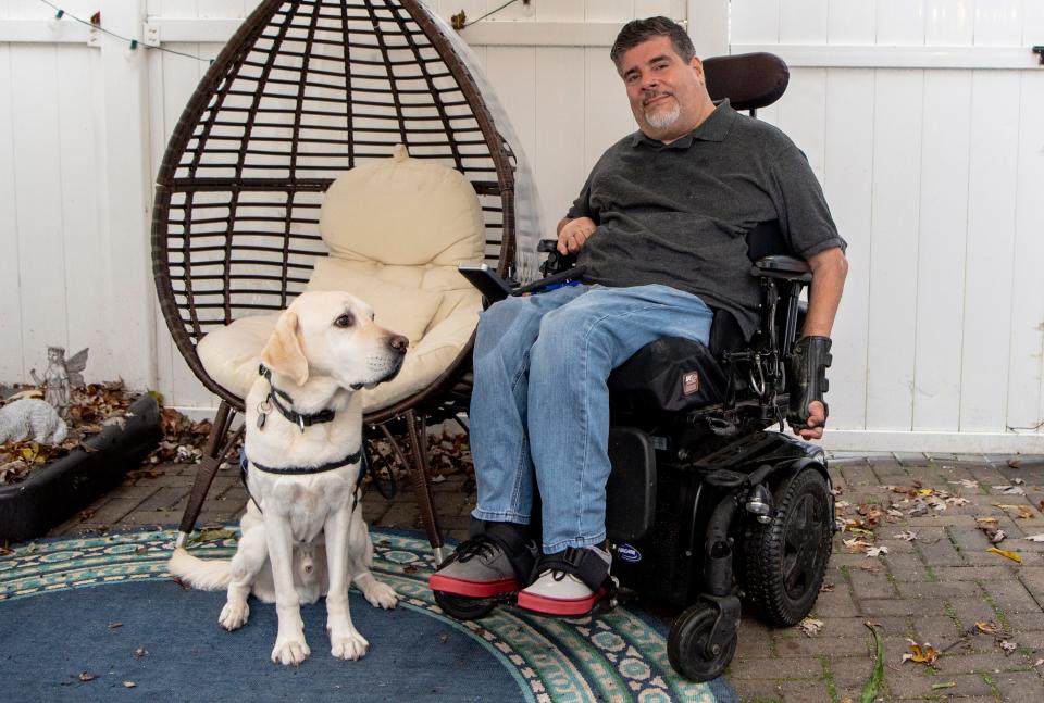 Javier Robles, Chair of the New Jersey COVID-19 Disabilities Action Committee, with his service dog Delbert at his Edison home on Wednesday November 11, 2020.