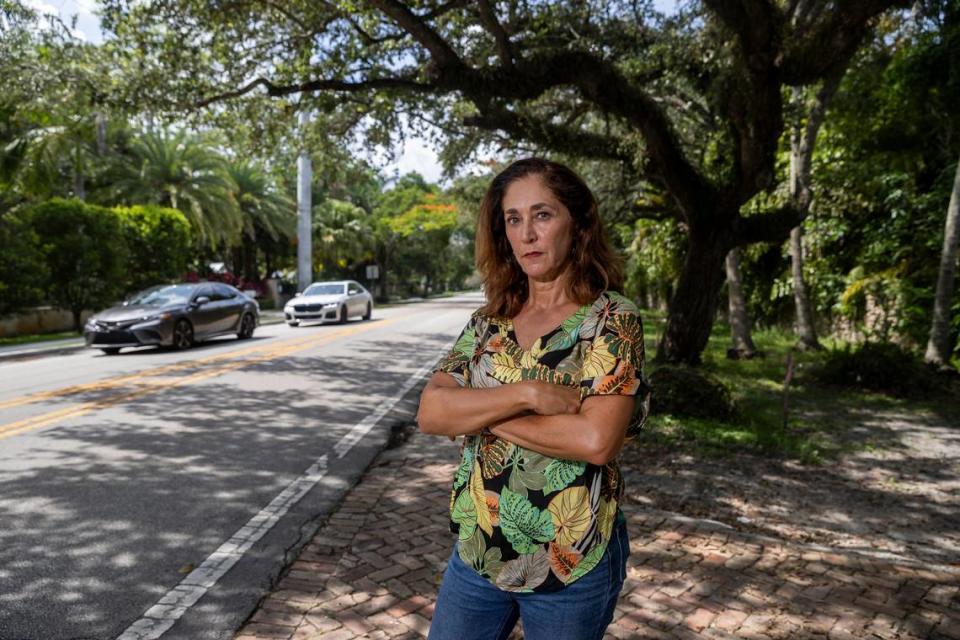 Betsy Wise is photographed in front of her home on Wednesday, June 28, 2023, in Pinecrest, Florida. Miami-Dade County is planning to build a traffic circle near Wise’s home at the intersection of Southwest 67th Avenue and Southwest 136th Street. Residents are now suing the county claiming the traffic circle would destroy trees and ruin the character of their streets.