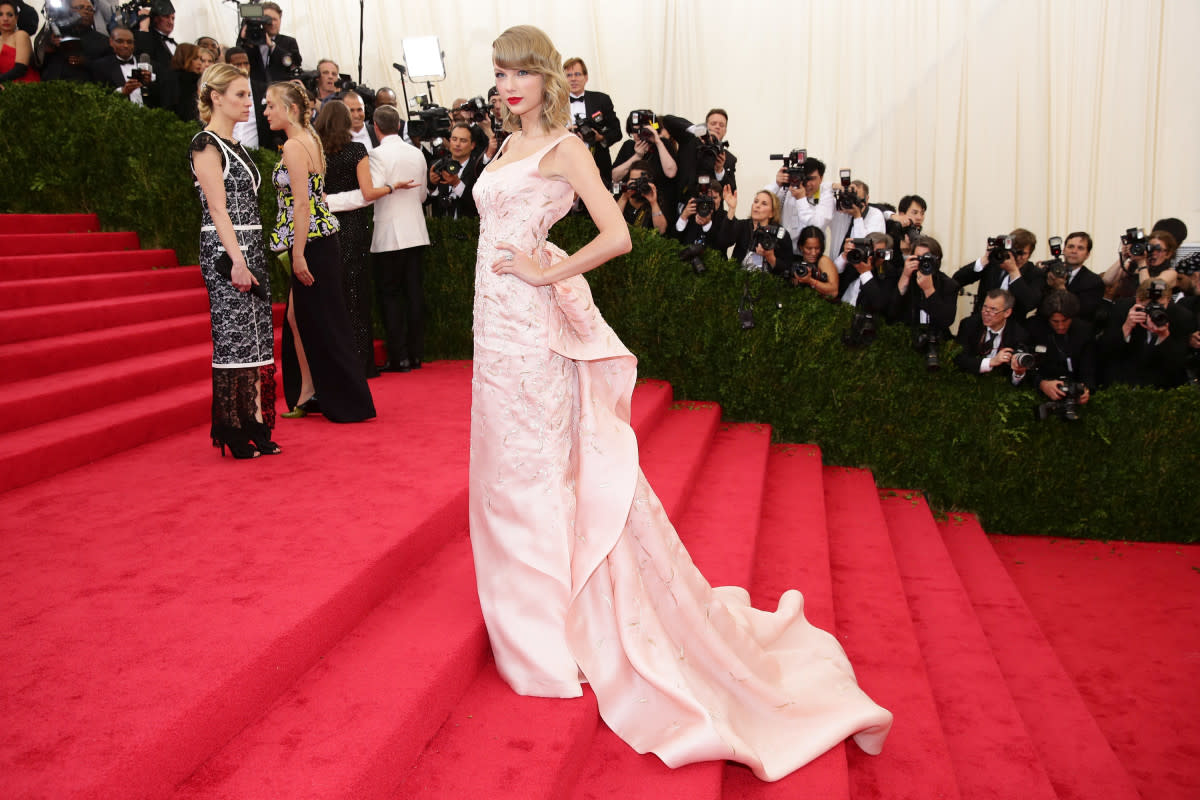 <p>Neilson Barnard/Getty Images</p><p>The following year, post-haircut and pre-<em>1989</em>, Swift wore this sumptuous pink Oscar de la Renta dress for the "Charles James: Beyond Fashion" theme. This is Swift's most "Met Gala" look with its long train and stunning detailing. Swift kept her red lip, but paired it with the bob haircut that would define the era. </p>