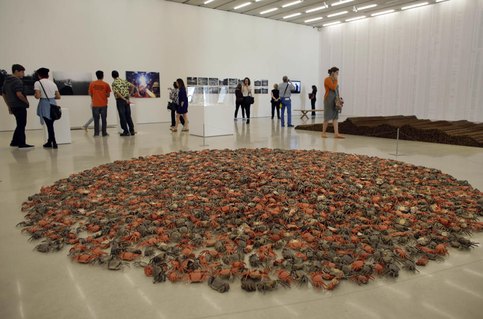 In this Saturday, Dec. 7, 2013 photo, a piece titled "He Xie" featuring 3,200 porcelain crabs, by the Chinese artist Ai Wei Wei, is on display at the Perez Art Museum Miami in Miami. The museum, called PAMM by locals, which opened in December, still lacks a permanent blockbuster, but its retrospective of Ai, on display through mid-March of 2014, should temporarily satisfy. (AP Photo/Lynne Sladky)