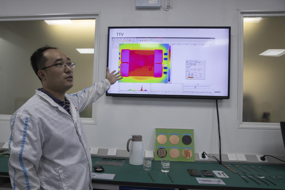 In this Aug. 21, 2019, photo, a Huawei research engineer describes the work done at the Huawei Thermal design lab in Dongguan in Southern China's Guangdong province. Facing a ban on access to U.S. technology, Chinese telecom equipment maker Huawei is showing it increasingly can do without American components and compete with Western industry leaders in pioneering research. (AP Photo/Ng Han Guan)