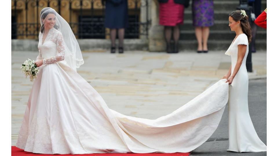 Pippa Middleton holds Kate Middleton's dress as she prepares to walk down the aisle