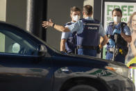 Police stand outside a supermarket in Auckland, New Zealand, Saturday, Sept. 4, 2021. New Zealand authorities say they shot and killed a violent extremist, Friday Sept. 3, after he entered a supermarket and stabbed and injured six shoppers. Prime Minister Jacinda Ardern described Friday's incident as a terror attack. (AP Photo/Brett Phibbs)