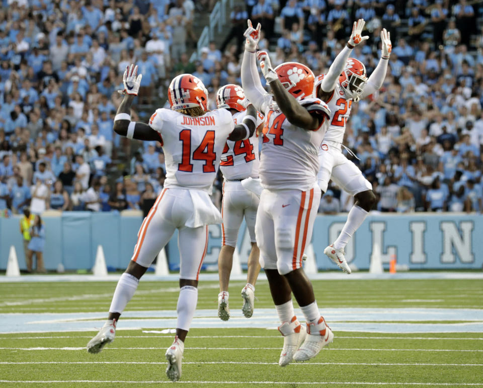 Clemson's Denzel Johnson (14), Nyles Pinckney (44), Nolan Turner (24) and Andrew Booth Jr. (23) celebrate after they stopped North Carolina on a two-point conversion in the closing moments of an NCAA college football game in Chapel Hill, N.C., Saturday, Sept. 28, 2019. (AP Photo/Chris Seward)