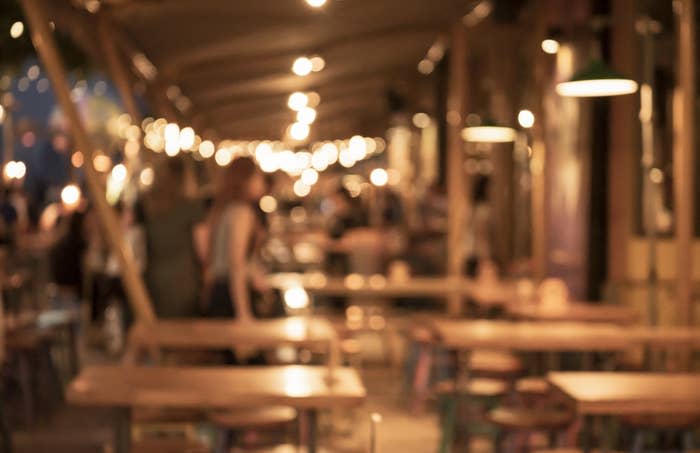 A blurry photo of an outdoor restaurant sitting space