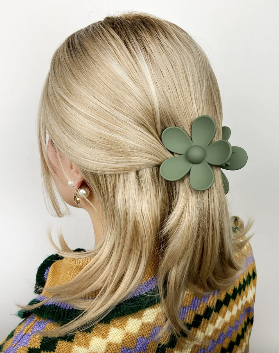 blonde woman wearing green Flower Hair Claw Clips (Photo via Etsy)