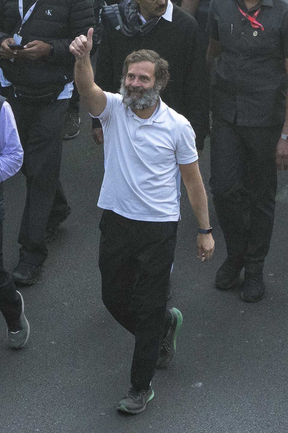 Rahul Gandhi, leader of India's opposition Congress party, gestures as he walks with his supporters during a march, in New Delhi, India, Saturday, Dec. 24, 2022. Rahul Gandhi, leader of India's beleaguered opposition Congress party, on Saturday marched in New Delhi along with his supporters, part of his five-month-long 3,570km (2,218-mile) countrywide trek through 12 states that began 105 days ago.(AP Photo/Altaf Qadri)