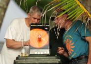 PALM COVE, AUSTRALIA - NOVEMBER 14: Spectators use an eclipse viewer to watch the total solar eclipse on November 14, 2012 in Palm Cove, Australia. Thousands of eclipse-watchers have gathered in part of North Queensland to enjoy the solar eclipse, the first in Australia in a decade. (Photo by Ian Hitchcock/Getty Images)