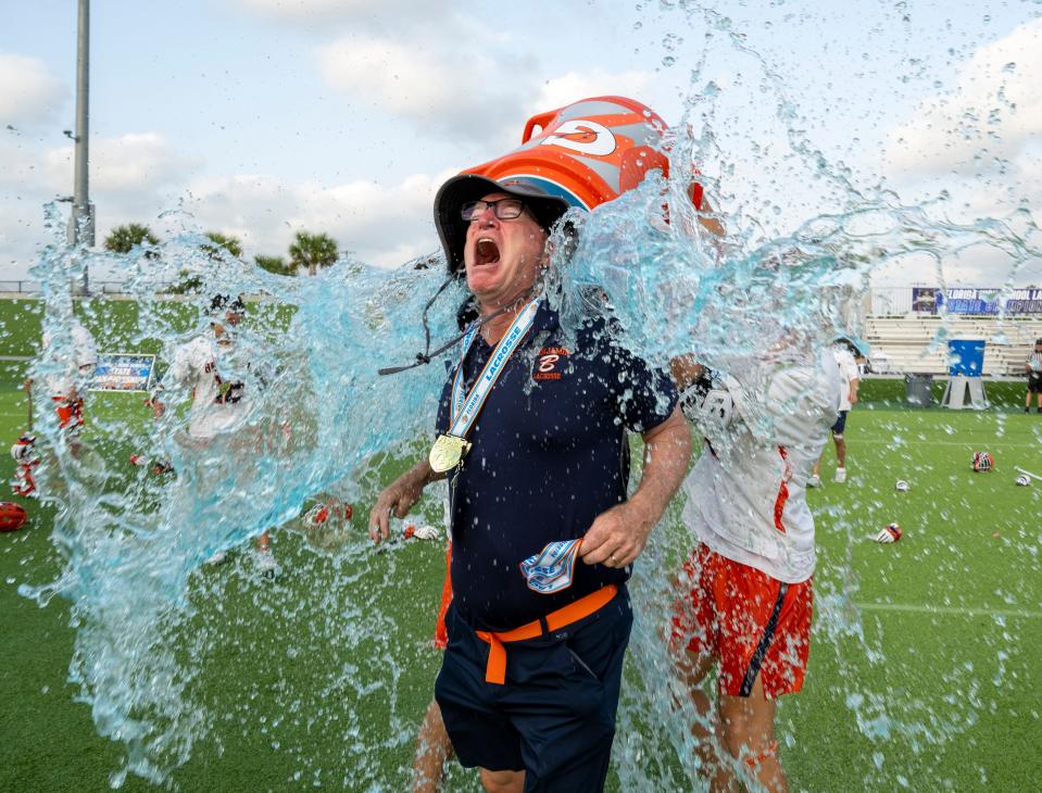 Head Coach Peter Cordrey of The Benjamin School is doused with gatorade as his team celebrates with after winning the Class 1A state championship game over Community School of Naples in Naples on Saturday evening, May 11, 2024. Photo by Darron R. Silva