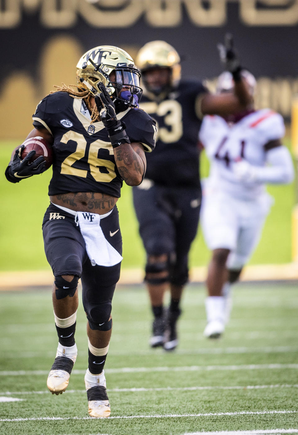 Wake Forest running back Christian Beal-Smith (26) runs the ball during an NCAA college football game against Virginia Tech on Saturday, Oct. 24, 2020 at Truist Field in Winston-Salem, N.C. (Andrew Dye/The Winston-Salem Journal via AP)