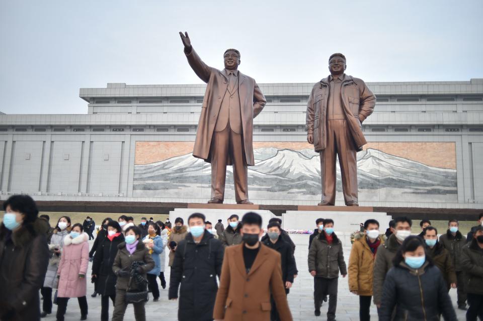 People visit the statues of North Korea's former president Kim Il Sung and chairman Kim Jong Il on Mansu Hill on the occasion of the lunar new year in Pyongyang on January 22, 2023. (Photo by KIM Won Jin / AFP) (Photo by KIM WON JIN/AFP via Getty Images)