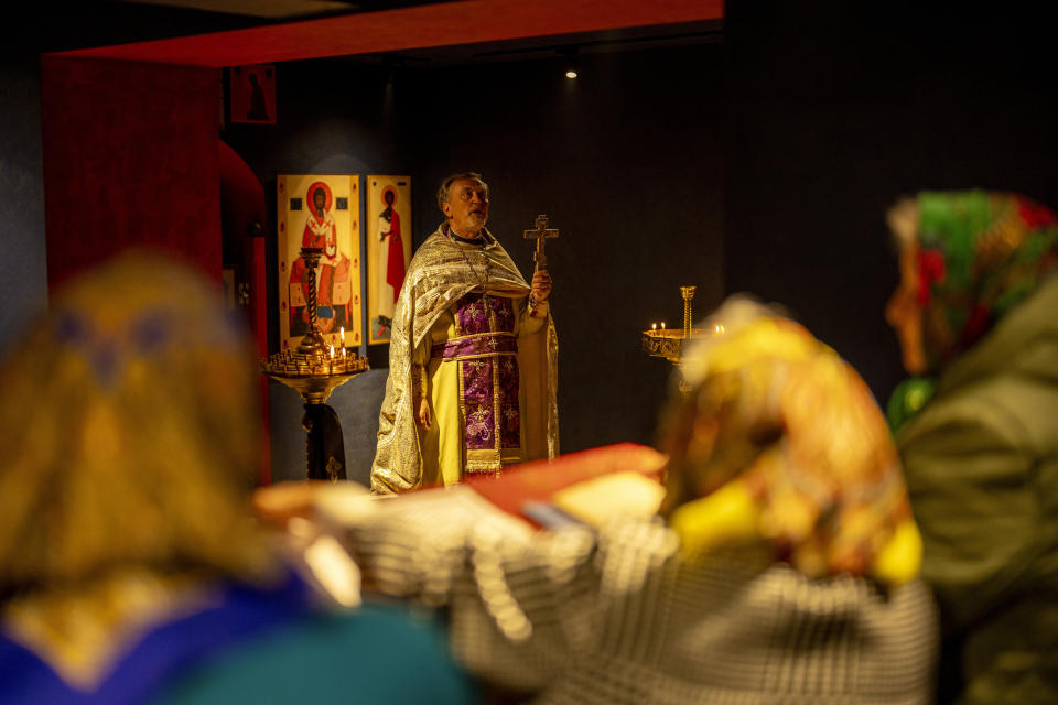 Christian Orthodox priest Hennadii Kharkivskyi leads a service at the chapel basement of the Church of the Intercession of the Blessed Virgin Mary in, Lypivka, near Lviv, Ukraine, Sunday, April 28, 2024. This Orthodox Easter season, an extraordinary new church is bringing spiritual comfort to war-weary residents of the Ukrainian village of Lypivka. Two years ago it also provided physical refuge from horrors outside. (AP Photo/Francisco Seco)