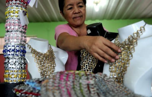 A worker arranges products made with push-tabs from aluminum beverage cans at the Philippine Christian Foundation building in Manila on June 13. In the midst of the Philippines' most notorious slum, British expat Jane Walker transforms lives by turning rubbish into top-end fashion items