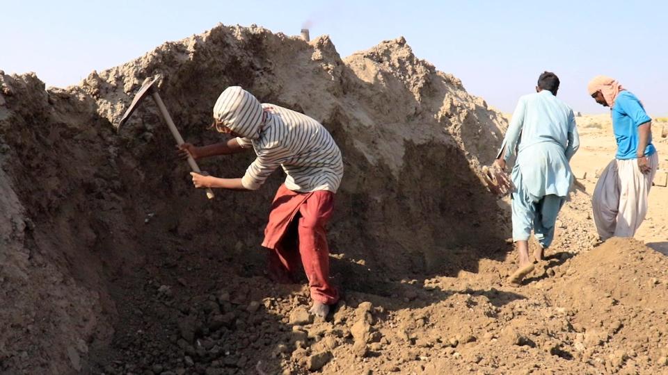 Worker digging up dirt