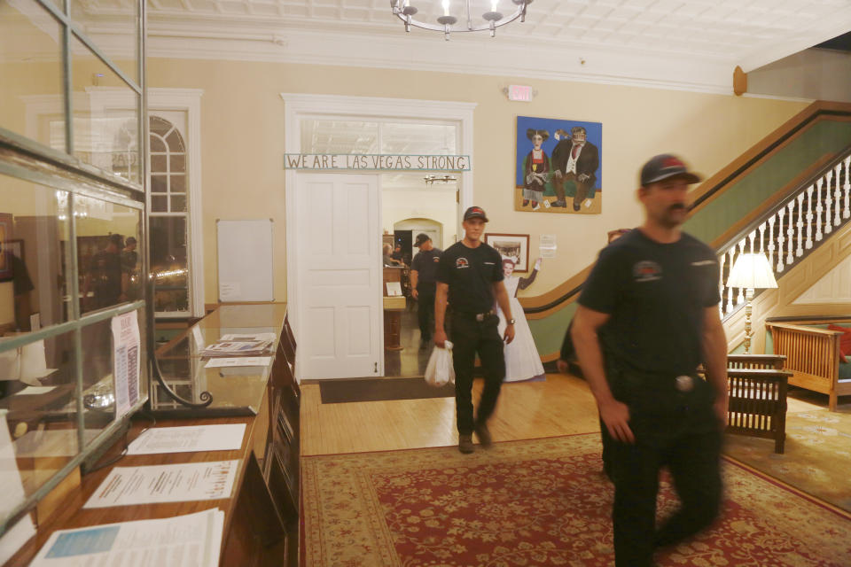 Wildland firefighters from various cities in California leave the The Castañeda Hotel after eating a hot meal in Las Vegas, N.M., on Saturday, May 7, 2022. The hotel is offering meals for displaced residents and firefighters. For many, it's the first meal they've hot meal had in days, or the first with silverware and a table. (AP Photo/Cedar Attanasio)