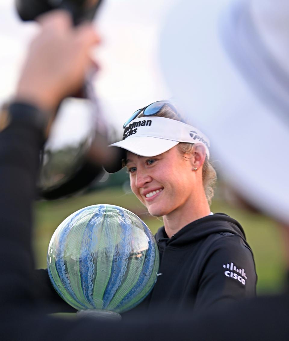Bradenton's Nelly Korda holds her new winning trophy after defeating Lydia Ko, off camera, in a sudden-death playoff to capture LPGA Drive On Championship at Bradenton's Country Club on Sunday, Jan. 28, 2024.