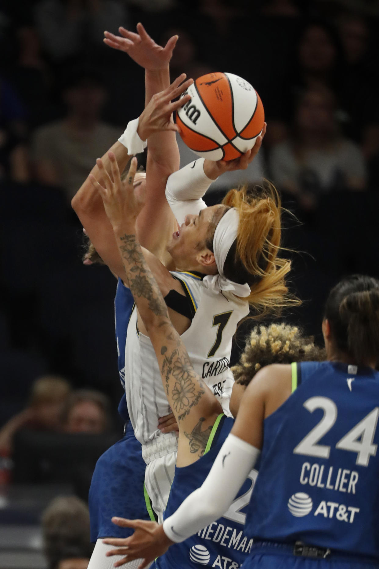 Minnesota Lynx forward Alanna Smith, rear, fouls Chicago Sky guard Chennedy Carter (7) as she shoots in the first quarter of a WNBA basketball game, Friday, Sept. 13, 2024, in Minneapolis. (AP Photo/Bruce Kluckhohn)