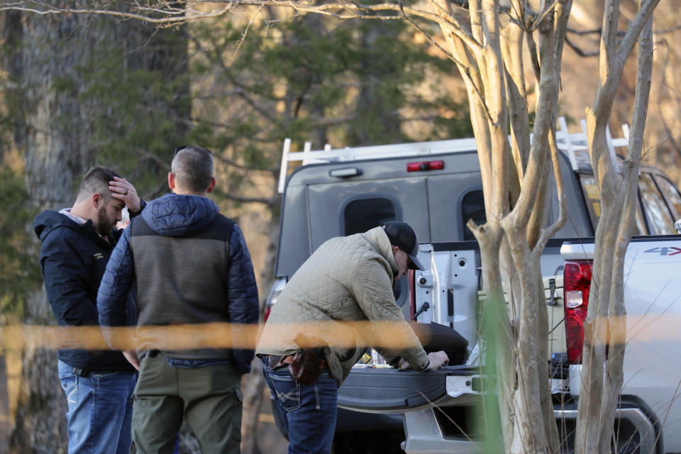 Law enforcement personnel investigate the scene of multiple shootings on Arkabutla Dam Road in Arkabutla, Miss on Friday, Feb. 17, 2023. Six people were fatally shot Friday at multiple locations in a small town in rural Mississippi near the Tennessee state line, and authorities blamed a lone suspect who was arrested and charged with murder. (AP Photo/Nikki Boertman)