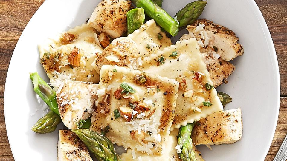 butternut squash ravioli with seared chicken in a bowl with asparagus