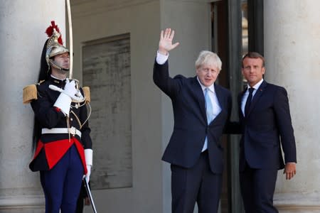 French President Emmanuel Macron and British Prime Minister Boris Johnson leave after a joint statement before a meeting on Brexit at the Elysee Palace in Paris