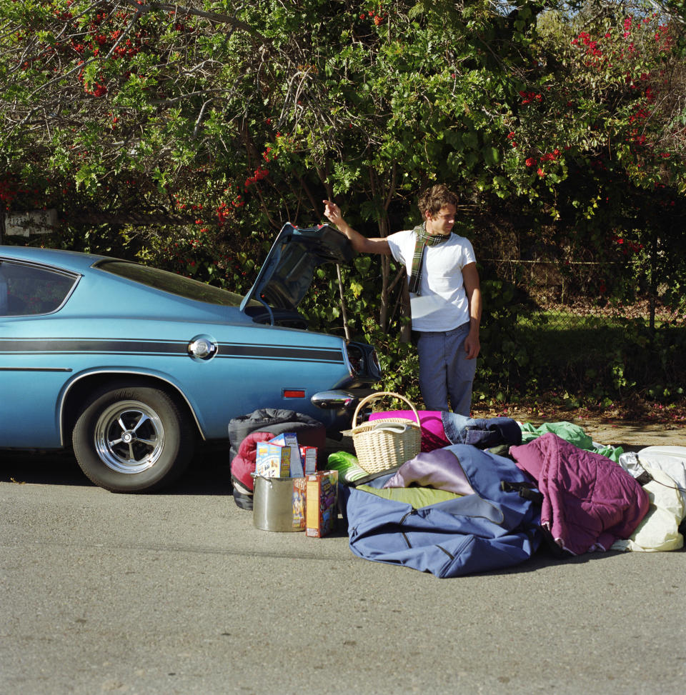 Man with luggage next to car. Source: Getty Images