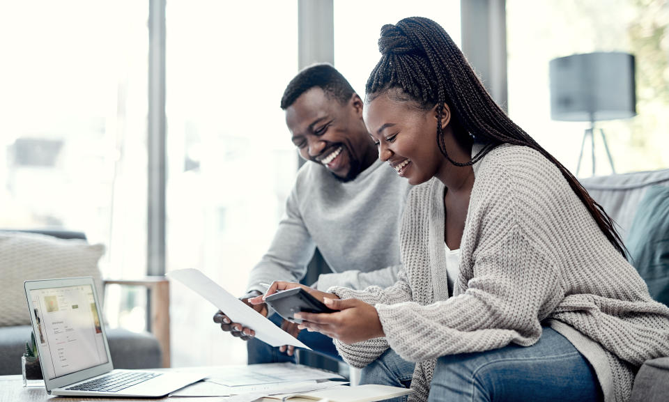 Shot of a young couple going through bills and paperwork at home