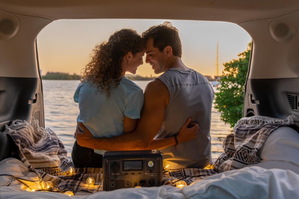 Guy and girl van camping with the Bluetti Portable Power Station EB3A.