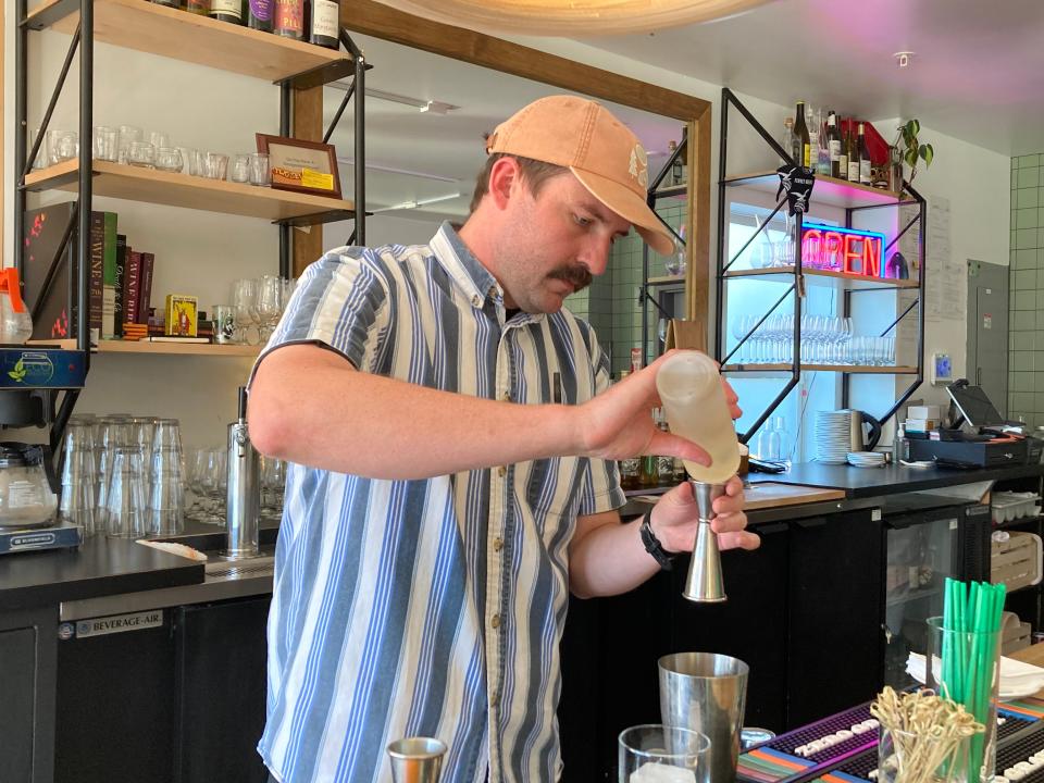 Matthew Peterson, co-owner of May Day, mixes a High Five (a mojito-like cocktail) at the Burlington restaurant June 24, 2022.
