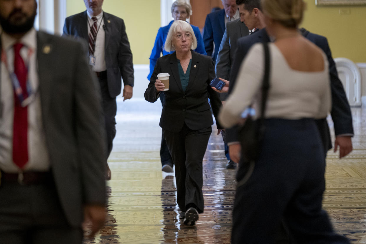 Senator Patty Murray walks down a hallway on her way to a meeting.