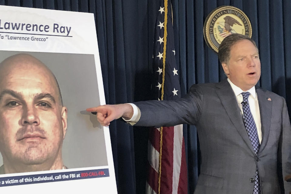 U.S. Attorney Geoffrey Berman points to a photo showing Lawrence Ray during a news conference, Tuesday, Feb. 11, 2020, in New York. Ray, an ex-convict known for his role in a scandal involving former New York police commissioner Bernard Kerik, was charged Tuesday with federal extortion and sex trafficking charges involving a group of students at Sarah Lawrence College. (AP Photo/Jim Mustian)