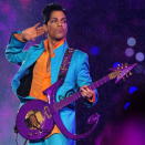 <div class="caption-credit"> Photo by: Getty Images/Theo Wargo</div>Fierce as always, Prince, in 2007, wore an electric-blue suit, bright-tangerine shirt and a major accessory: his purple, logo-shaped guitar.