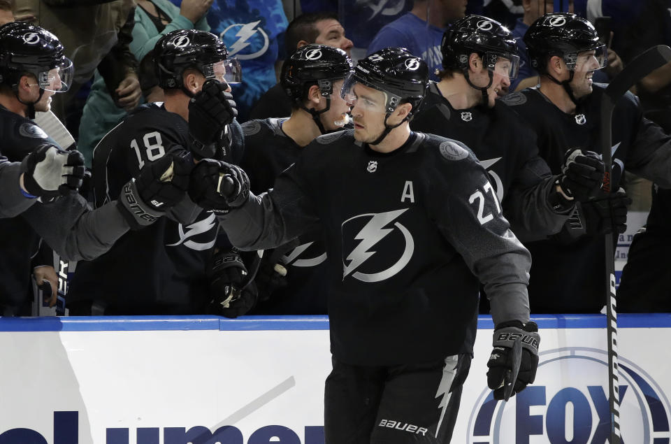 Tampa Bay Lightning defenseman Ryan McDonagh (27) celebrates with the bench after his goal against the Ottawa Senators during the first period of an NHL hockey game Saturday, March 2, 2019, in Tampa, Fla. (AP Photo/Chris O'Meara)