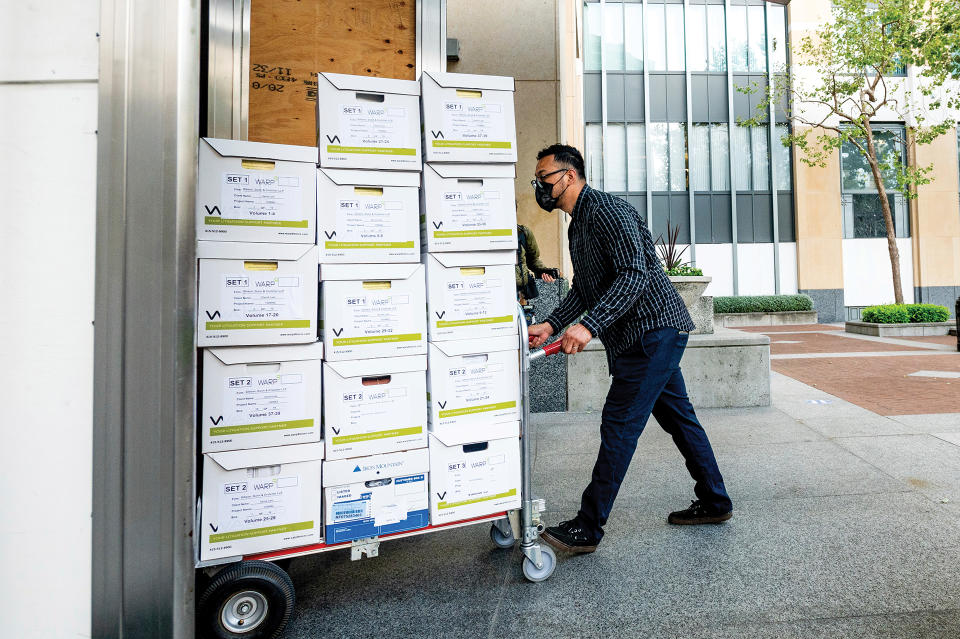 A member of Apple’s legal team brings exhibit boxes into the Ronald V. Dellums building in Oakland, Calif., on May 3, as the company battles Epic Games in federal court. - Credit: AP