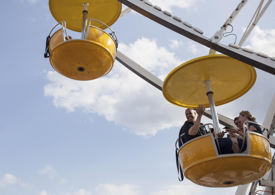 Sen. Cory Booker (D-N.J.) rides the Ferris wheel with reporters on Saturday, Aug. 10, 2019, at the Iowa State Fair. (Photo: Seth Herald for HuffPost)