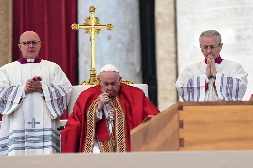 Pope Francis prays by The coffin of Pope Emeritus Benedict XVI during his funeral mass at St. Peter's square in the Vatican, (AFP via Getty Images)