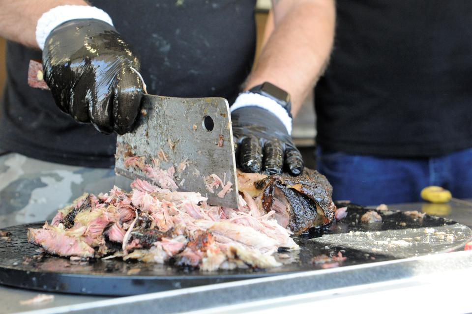 Dan Lashbrooke chops a smoked pork butt in his Lashbrooke's Barbecue trailer on Friday, April 9, 2021. Lashbrooke's Barbecue will be one truck in Downtown Evansville during the eclipse on Monday, Apr. 8.