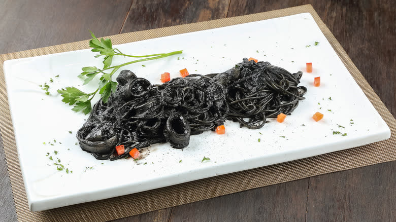 squid ink pasta on rectangular plate 